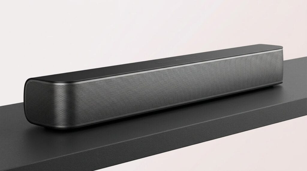 Sleek black Dolby Atmos soundbar on a modern shelf with soft directional light, featured guide image