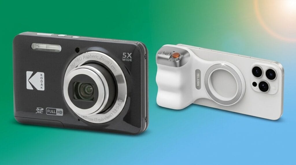 Kodak digital camera and smartphone with multiple lenses side by side on a tabletop under soft light